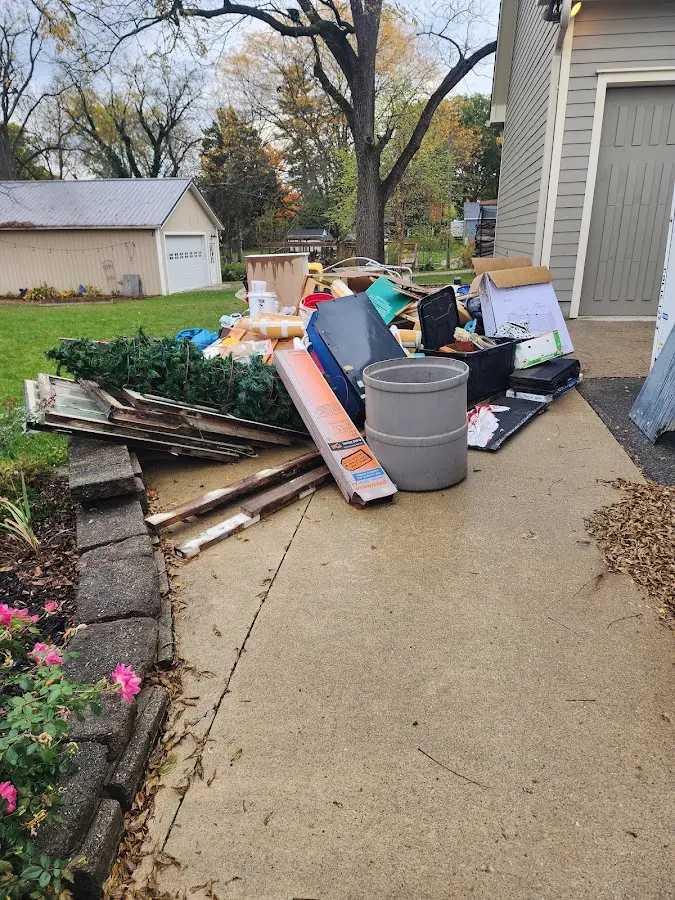 Dumpster being loaded with debris for Estate Cleanout Dumpster Rental in Mableton